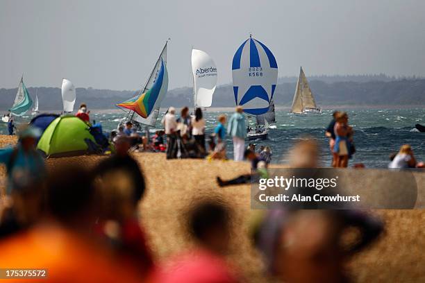 Spectators on the beach watch as the yachts make their way toward the finish during day one of the Aberdeen Asset Management Cowes Week on August 03,...