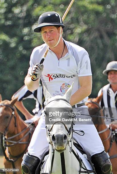 Prince Harry plays in the Audi Polo Challenge at Coworth Park Polo Club on August 3, 2013 in Ascot, England.