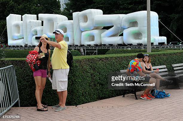 Couple takes a selfie with a camera phone during Lollapalooza at Grant Park on August 2, 2013 in Chicago, Illinois.