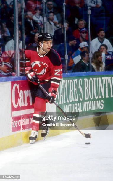 Scott Niedermayer of the New Jersey Devils skates with the puck during an NHL game against the New York Islanders circa 1995 at the Nassau Coliseum...