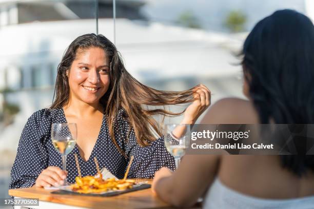 two young women sitting in a restaurant, - lesbians flirting stock pictures, royalty-free photos & images