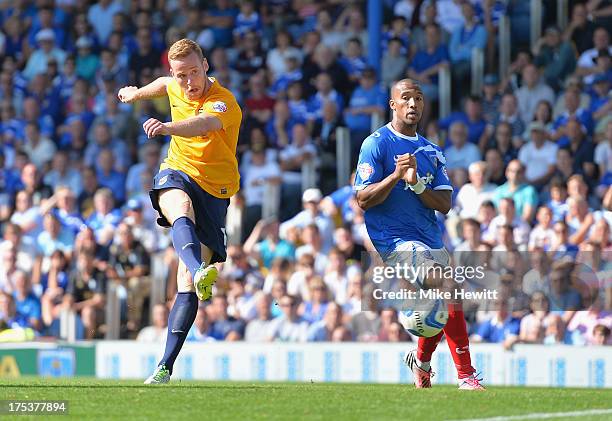 Deane Smalley of Oxford smashes home his side's fourth goal despite the efforts of Yassin Moutaouakil of Portsmouth during the Sky Bet League Two...