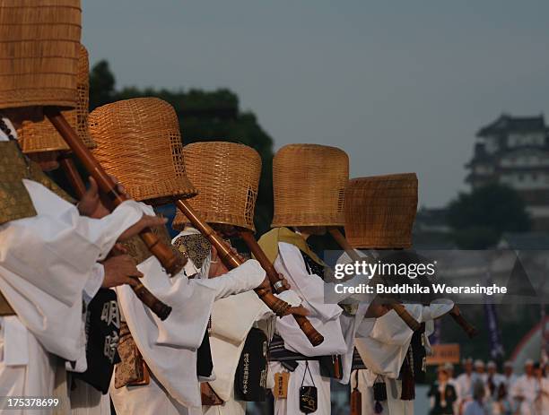 Japanese Shakuhachi players perform traditional bamboo flutes during the annual Himeji Castle Festival on August 3, 2013 in Himeji, Japan. The parade...