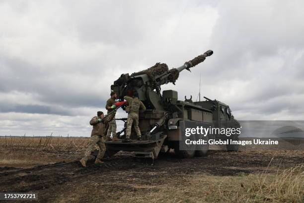 Ukrainian soldiers load 2S22 Bohdana self-propelled howitzer during firing on Russian position on October 17, 2023 in Donetsk Oblast, Ukraine.