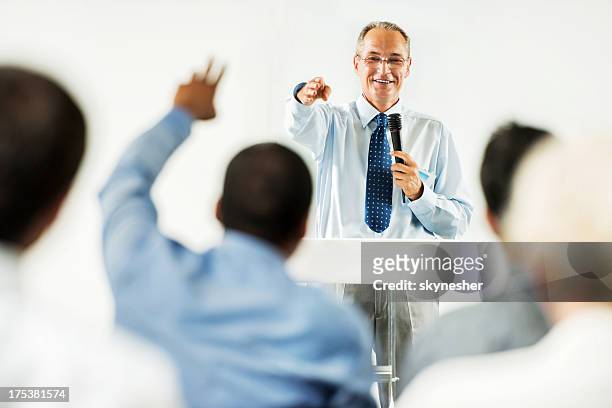 mature adult man having a public speech. - auction stock pictures, royalty-free photos & images