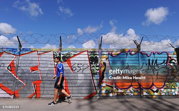 Pompey fan walks down an alley behind Fratton Park ahead of the Sky Bet League Two match between Portsmouth and Oxford United at Fratton Park on...