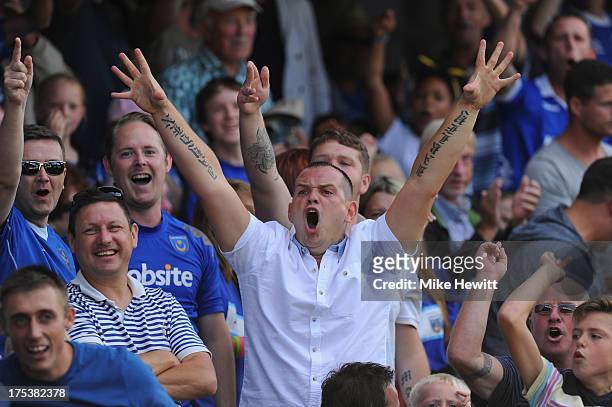 Portsmouth fans celebrate their team's early goal during the Sky Bet League Two match between Portsmouth and Oxford United at Fratton Park on August...