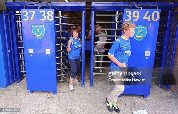 Portsmouth fans come through the turnstiles ahead of the Sky Bet League Two match between Portsmouth and Oxford United at Fratton Park on August 03,...