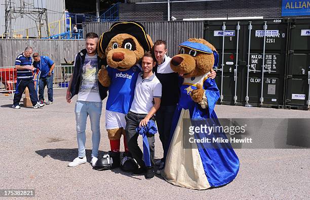 Fans pose with the club mascots ahead of the Sky Bet League Two match between Portsmouth and Oxford United at Fratton Park on August 03, 2013 in...