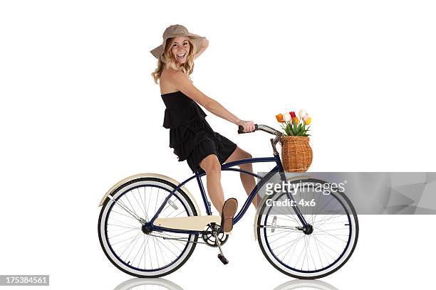 attractive woman riding a bicycle - bike flowers stock pictures, royalty-free photos & images