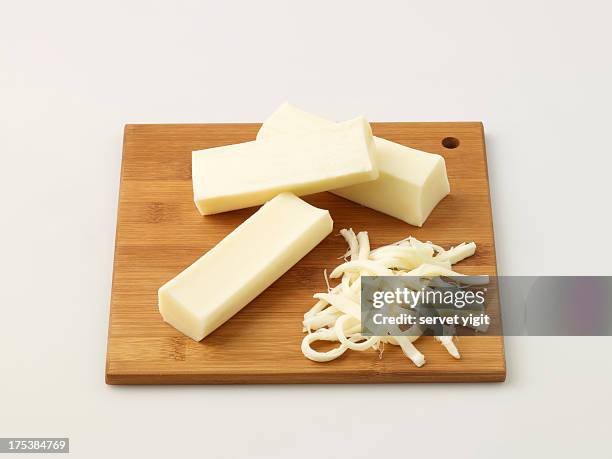 string cheese on chopping board - mozzarella stock pictures, royalty-free photos & images