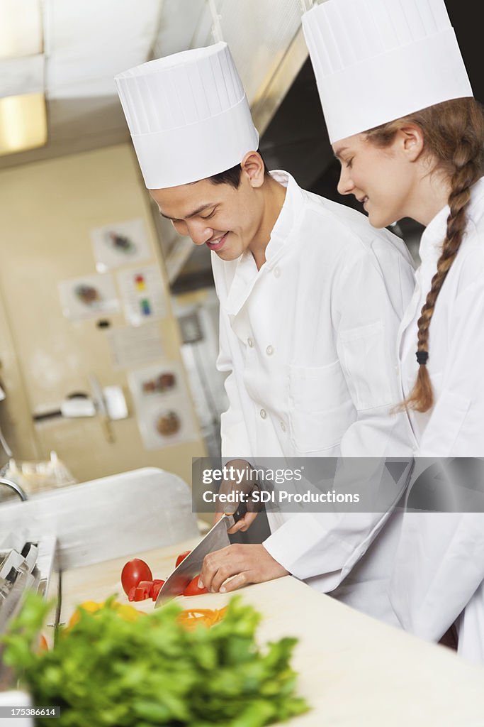 Chef Mentor Training Apprentice On Preparing Fine Food High-Res Stock ...