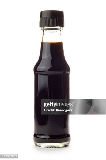glass bottle of soy sauce isolated on a white background - shoyu stockfoto's en -beelden