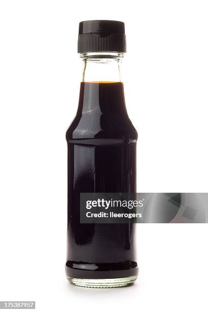 glass bottle of soy sauce isolated on a white background - sojasaus stockfoto's en -beelden
