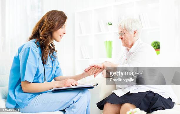 doctor checking psoriasis on senior woman patient hand. - psoriasis stock pictures, royalty-free photos & images