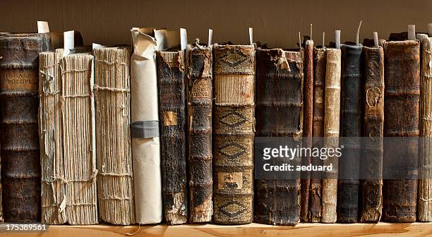 antique books in a library - science religion stock pictures, royalty-free photos & images