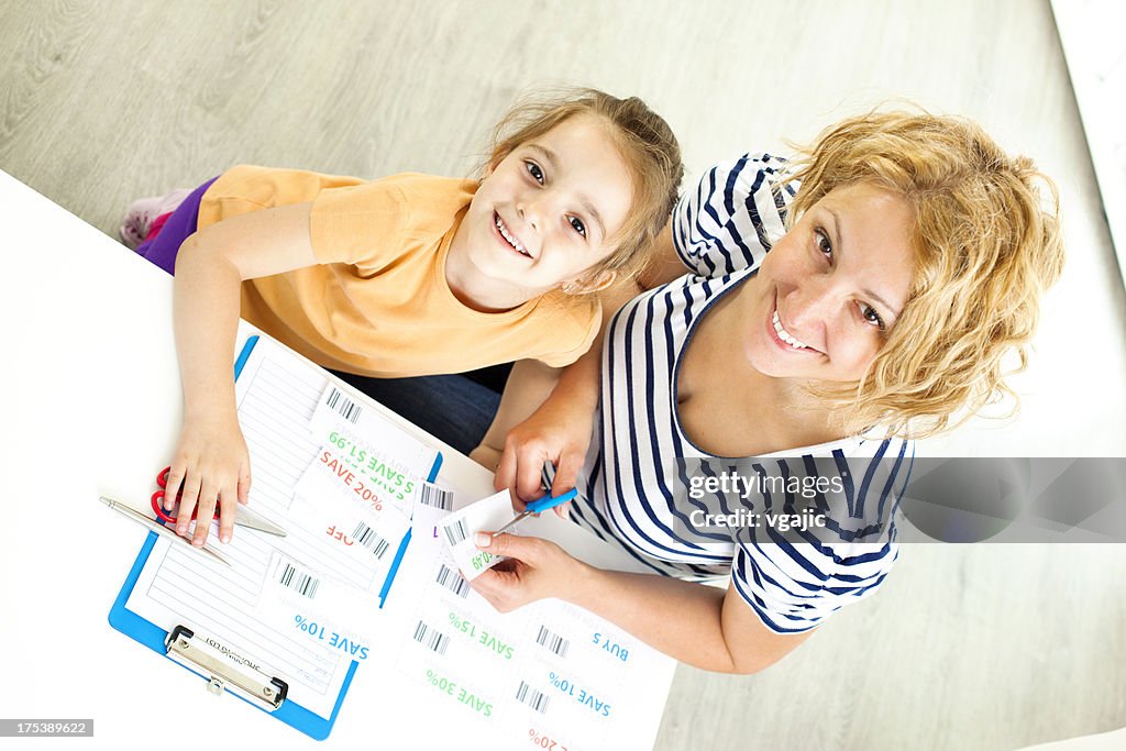Family Making Shopping list and coupons.