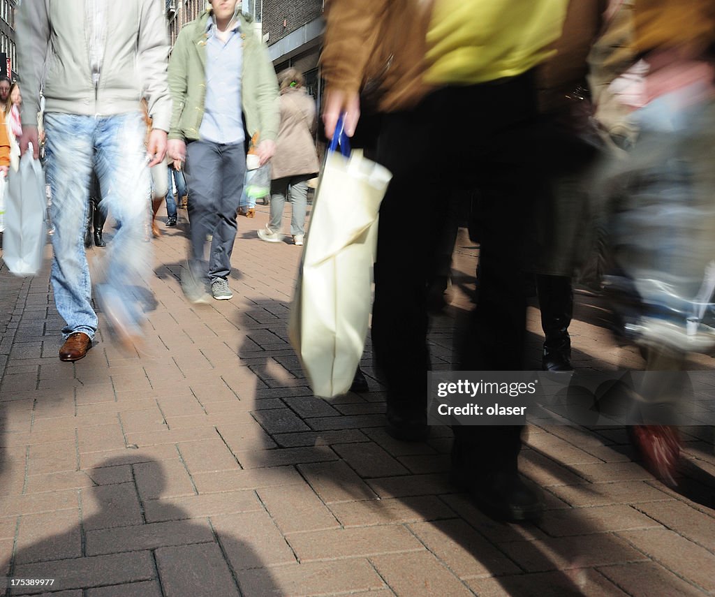 Motion blurred picture of people walking on street