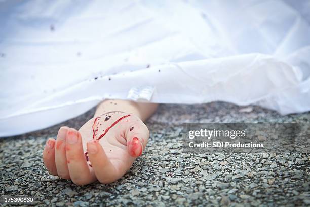 bloody hand at an accident scene pavement - dead female bodies stock pictures, royalty-free photos & images