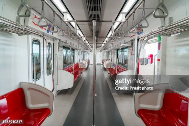 the empty interior of a subway train - grab handle stock pictures, royalty-free photos & images