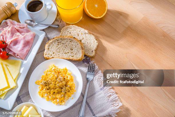 scrambled eggs, cheese, ham, coffee and fruit juice for breakfast - scrambled egg roll stock pictures, royalty-free photos & images