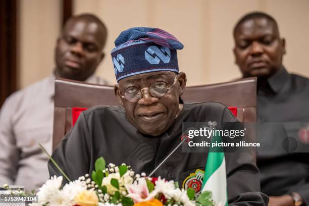 October 2023, Nigeria, Abuja: Bola Tinubu, President of Nigeria, attends a press conference at State House. Scholz is on his third major trip to...