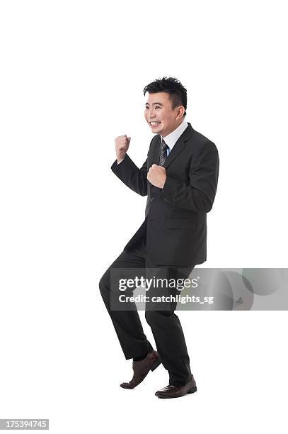 asiatische business mann - faust in die luft stoßen stock-fotos und bilder