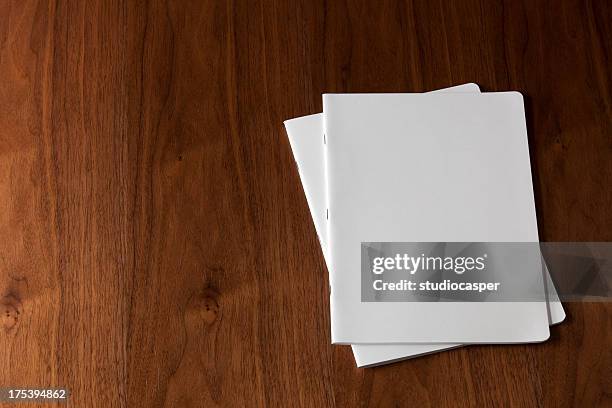 two blank magazines on a wooden floor - blank magazine stock pictures, royalty-free photos & images