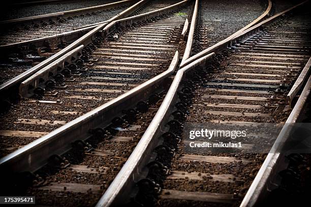 train line crossing with cross overs - train yard at night stock pictures, royalty-free photos & images