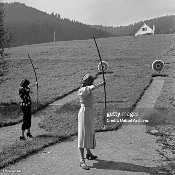 Two women exercising archery, Germany 1930s.