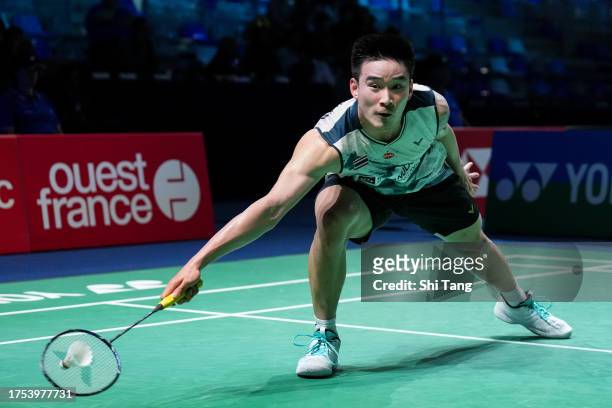 Kantaphon Wangcharoen of Thailand competes in the Men's Singles First Round match against Kodai Naraoka of Japan during day one of the Yonex French...
