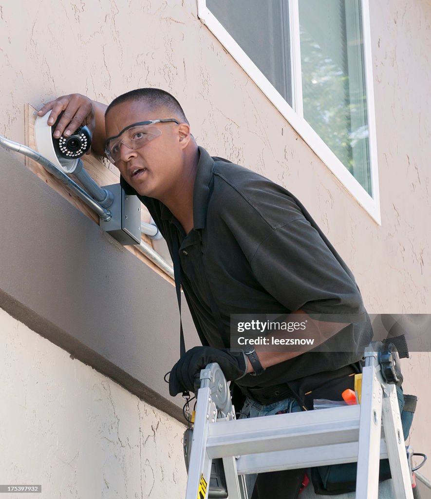 Technician installing security camera