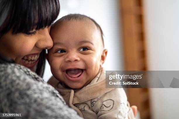 snuggling in with mum - bebis bildbanksfoton och bilder