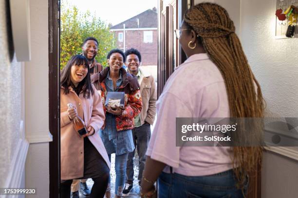 freunde, die zu einem geselligen beisammensein ankommen - nachbar stock-fotos und bilder
