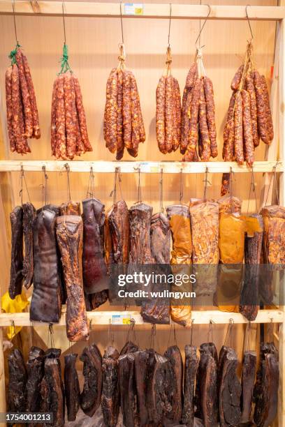 hanging xiangxi cured pork and sausages for sale - smoked stock pictures, royalty-free photos & images