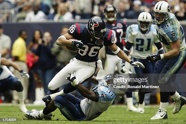 Wide receiver Jabar Gaffney of the Houston Texans is tackled by Safety Lance Schulters of the Tennessee Titans during the NFL game at Reliant Stadium...
