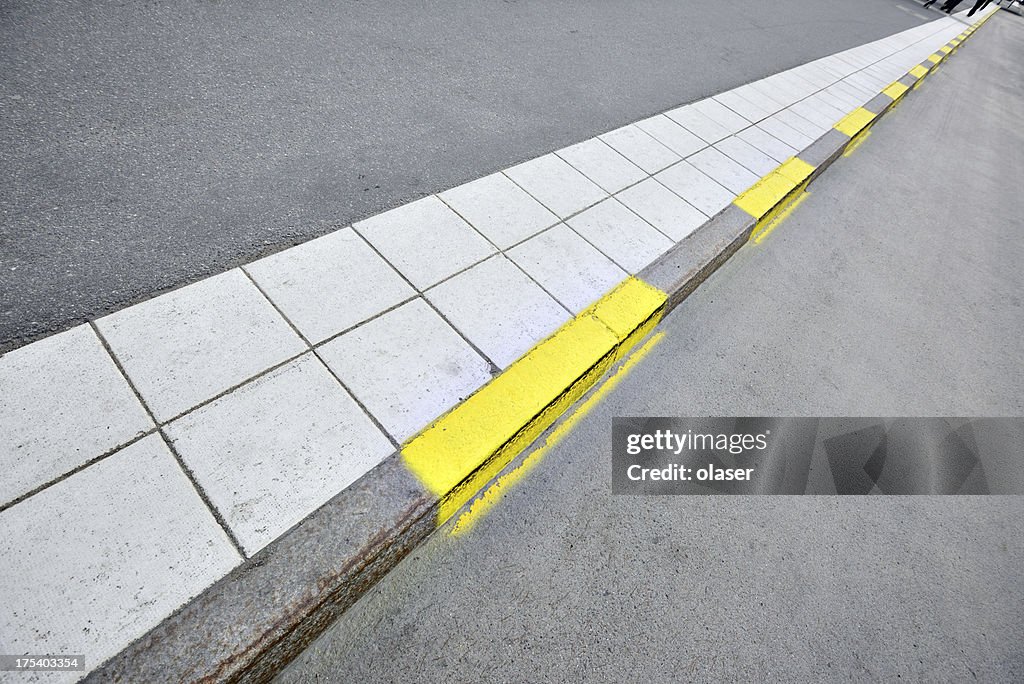 Sidewalk and yellow road markings
