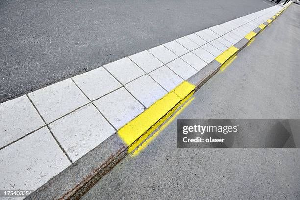 sidewalk and yellow road markings - kerb stock pictures, royalty-free photos & images