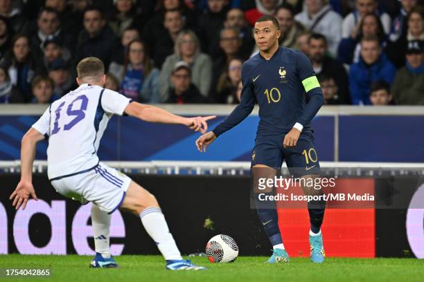 Lewis Ferguson of Scotland pictured defending on Kylian Mbappe of France during a soccer game between the national teams of France and Scotland in...