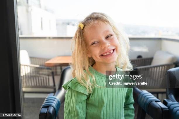 portrait of smiling girl with tooth gap - portrait of a young girl with gappy teeth and blond hair stock pictures, royalty-free photos & images