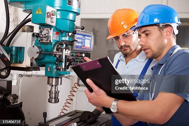 young engineer and foreman - manufacturing machinery stockfoto's en -beelden