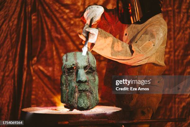 Worker positions the head of a monument to Civil War General Robert E. Lee that formerly stood in Charlottesville, Virginia before it is melted at a...