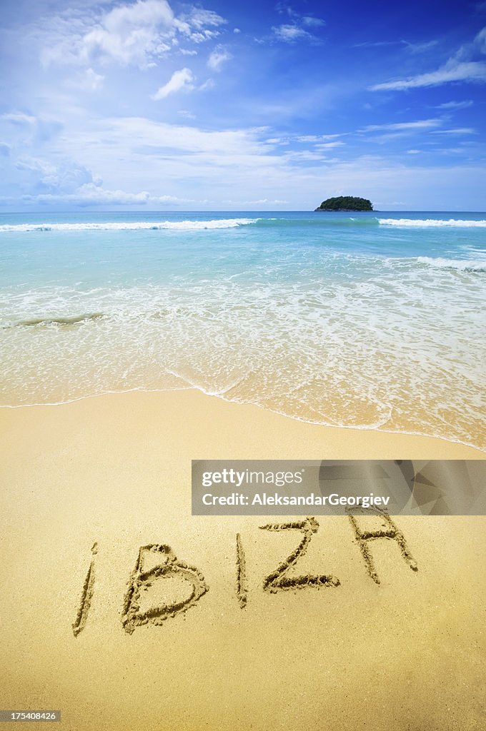 Ibiza written in the sand of a tropical beach