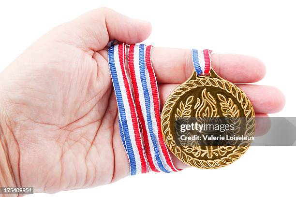 gold medal in hand - gold medal stock pictures, royalty-free photos & images