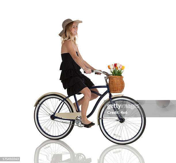 profile of happy beautiful woman riding a bicycle - bike white background stockfoto's en -beelden