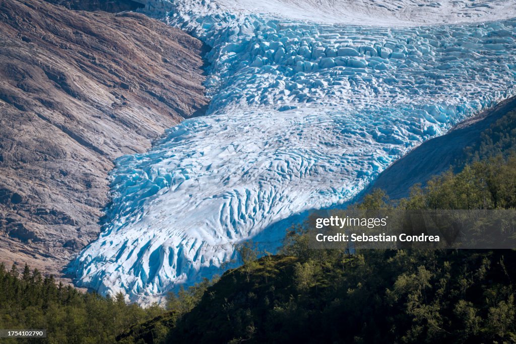 Briksdalsbreen glacier in the mountains of Jostedalsbreen national park in Norway, blue ice melting in summer.