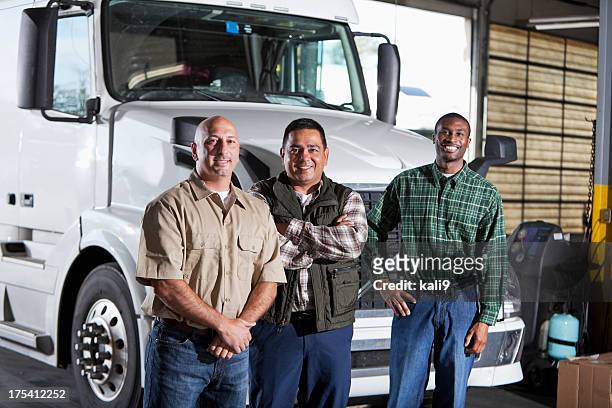 multi-ethnic men standing next to semi-truck - trucker stock pictures, royalty-free photos & images