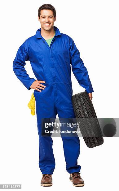 automotive technician holding a spare tyre - isolated - uniform werk stockfoto's en -beelden