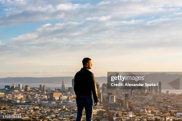 man looking at san francisco skyline from above at sunrise, california, usa - in the center stock pictures, royalty-free photos & images