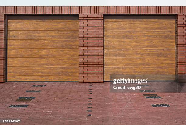 double garage - brick house door stock pictures, royalty-free photos & images